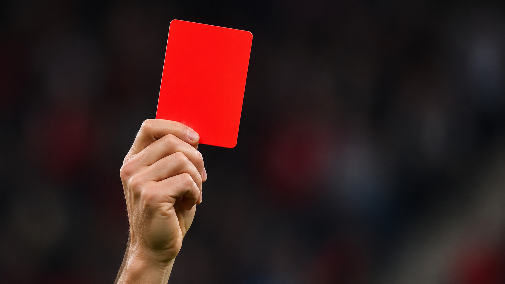 a picture of a referee showing a red card
