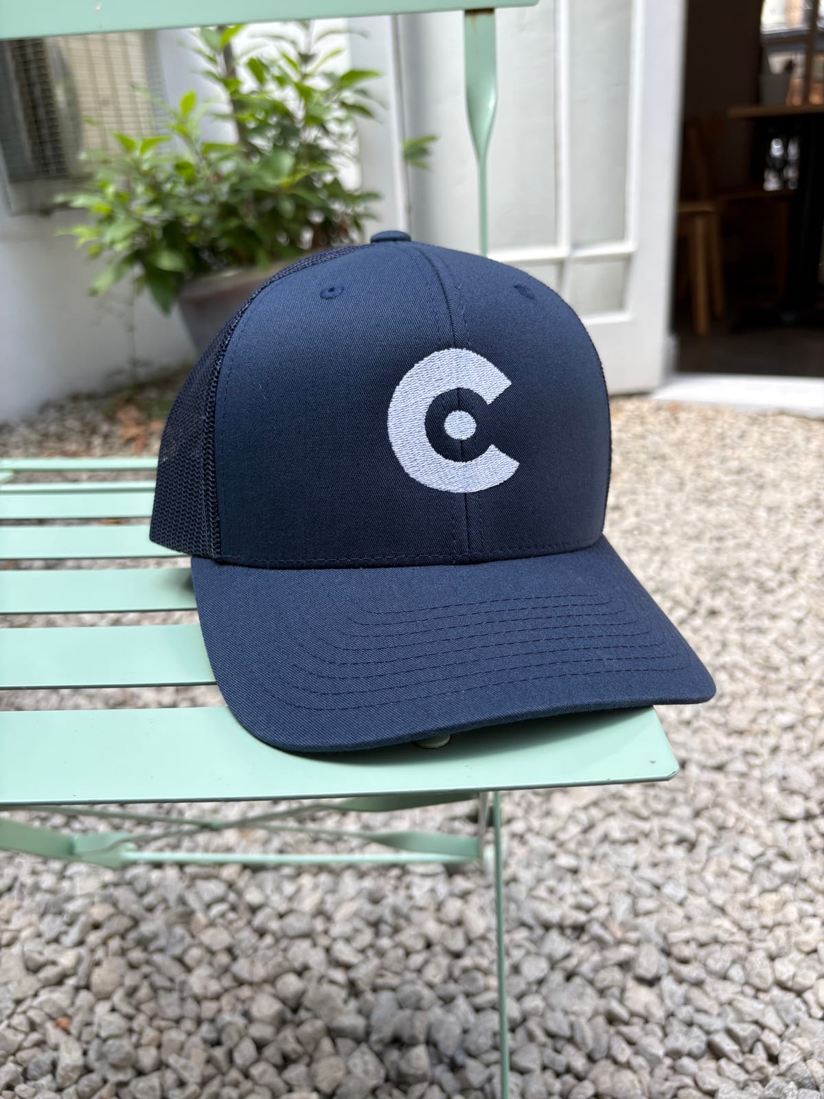 a picture of the CobbleRose Trukcer hat, perched on a chair.